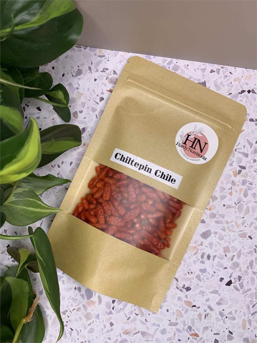 A jar of dried chiltepin chile.
