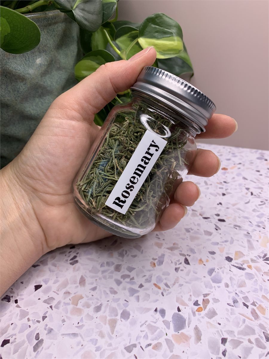 A jar of dried rosemary.
